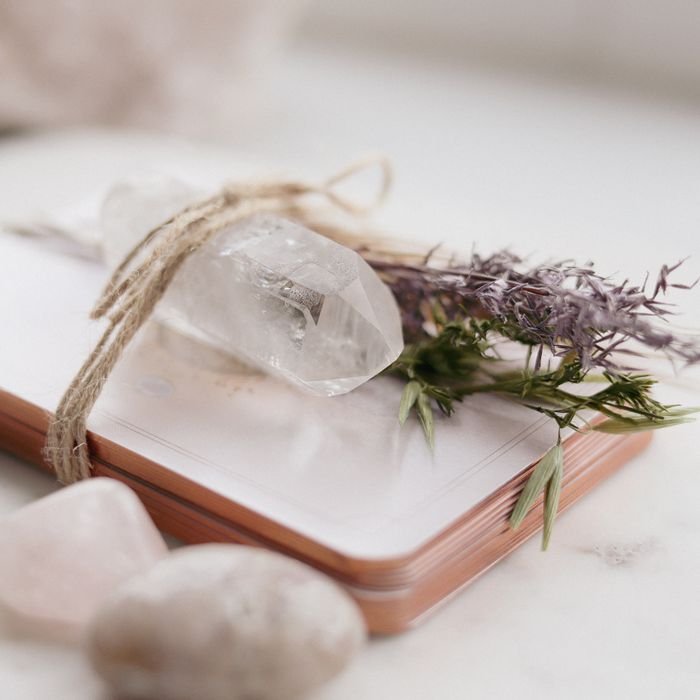 A serene composition of a quartz crystal, lavender, and spiritual cards for meditation.
